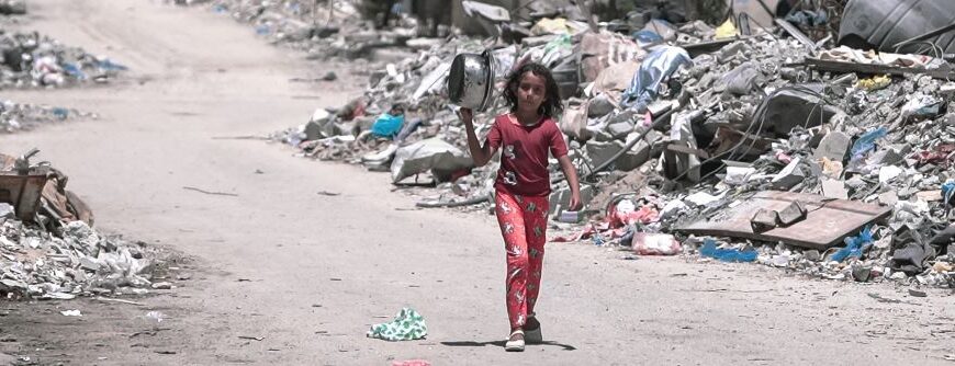 Gaza failed ceasefire - a girl walks through Gaza during the Israel Gaza war to get food.